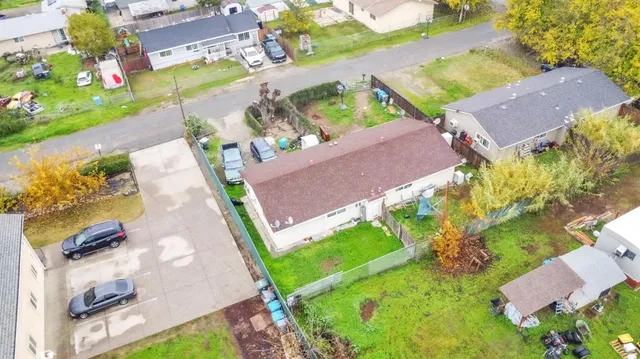 an aerial view of a house with a garden and swimming pool