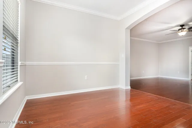 a view of a room with an empty space and window