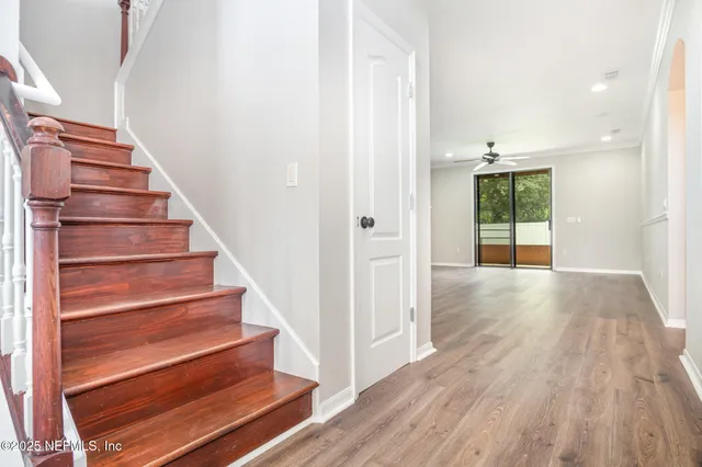 a view of entryway and hall with wooden floor