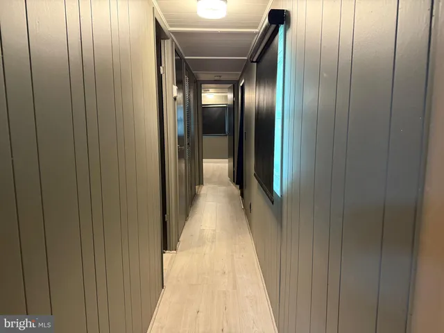 a view of a hallway with paintings on the wall