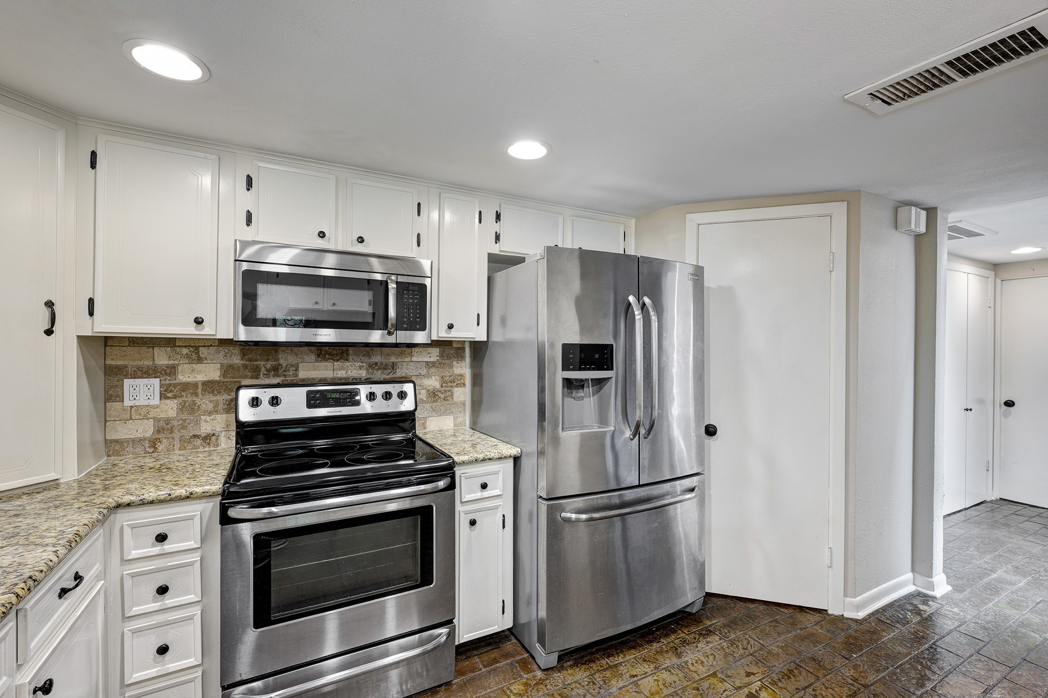 1122 Autrey Street, Unit 5 Houston, TX 77006 - Photo 7 of 32 a kitchen with stainless steel appliances a refrigerator stove and white cabinets