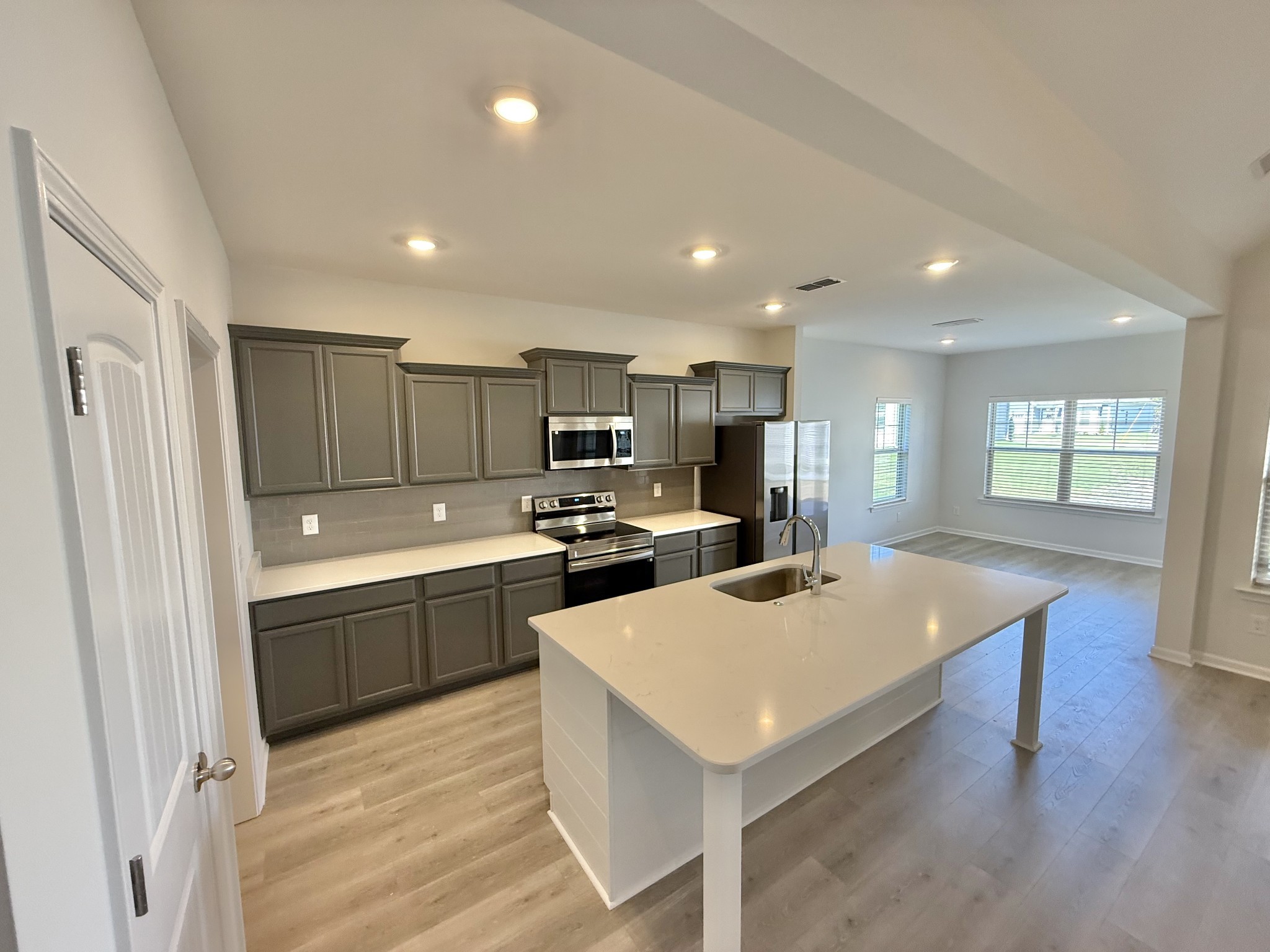 25 Ellie Jan Way Manchester, TN 37355 - Photo 4 of 12 a kitchen with a refrigerator a sink dishwasher and a refrigerator with wooden floor