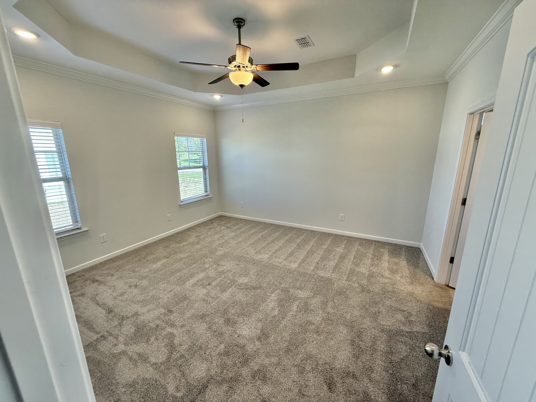 25 Ellie Jan Way Manchester, TN 37355 - Photo 7 of 12 an empty room with a chandelier fan and windows