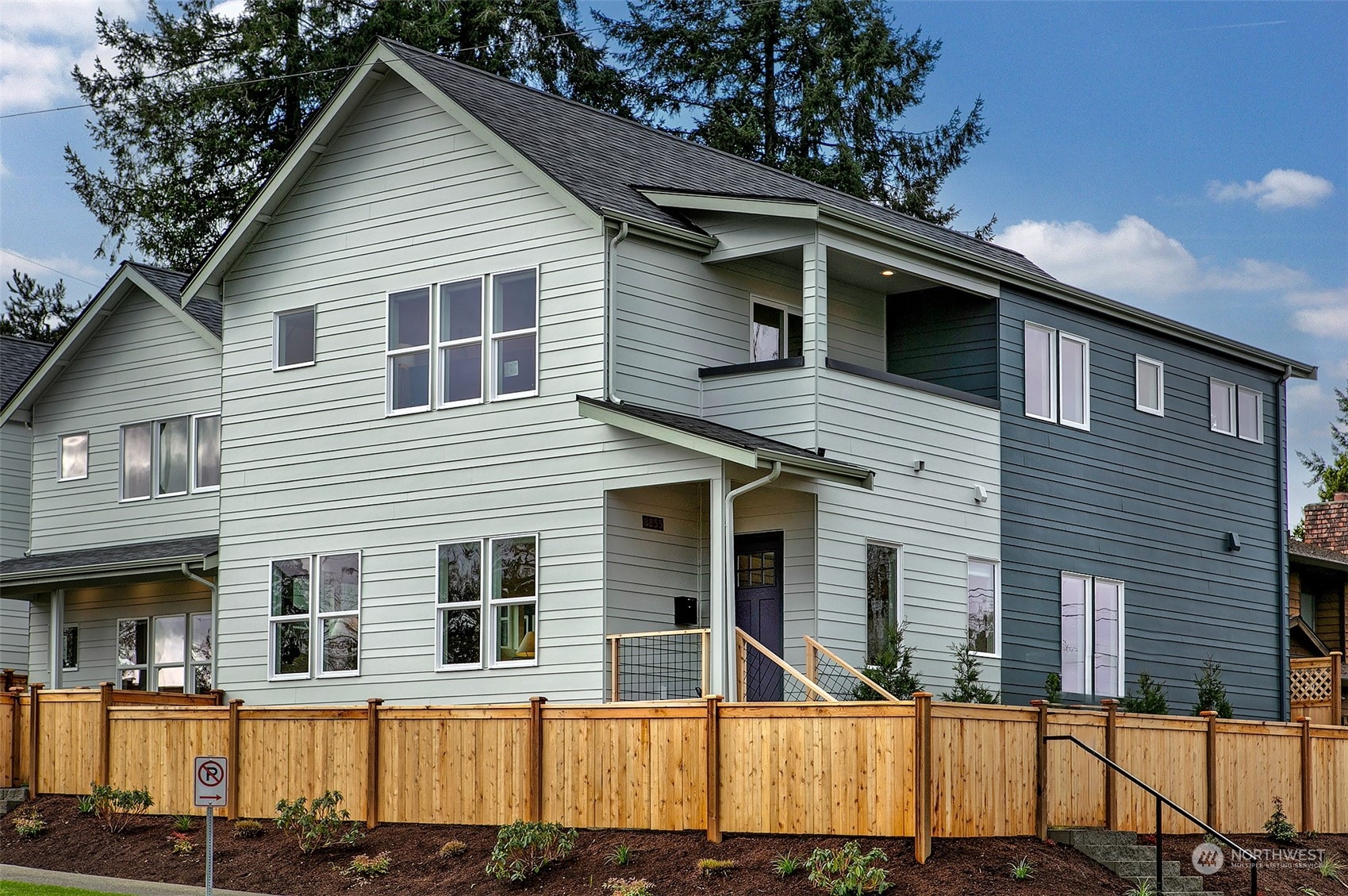 a view of a house with wooden fence