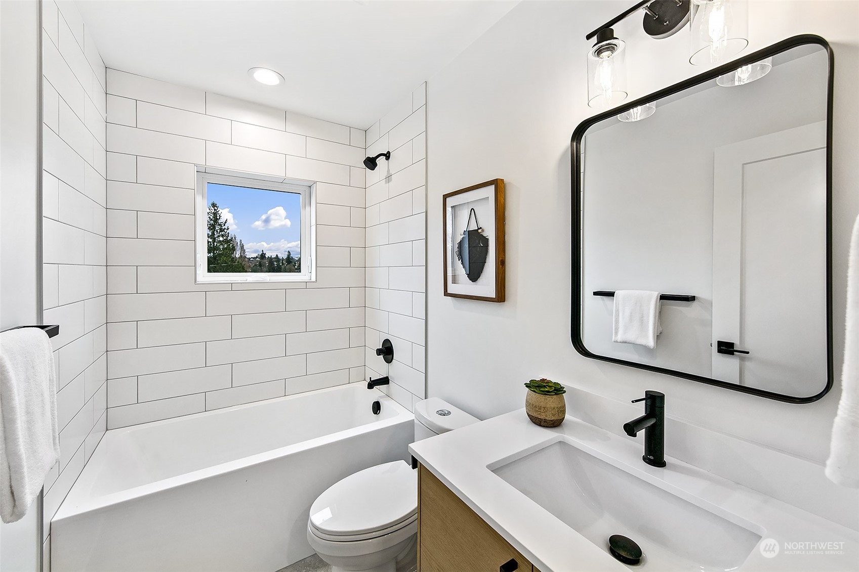 8855 29th Avenue Southwest Seattle, WA 98126 - Photo 14 of 20 a bathroom with a sink a toilet and a tub