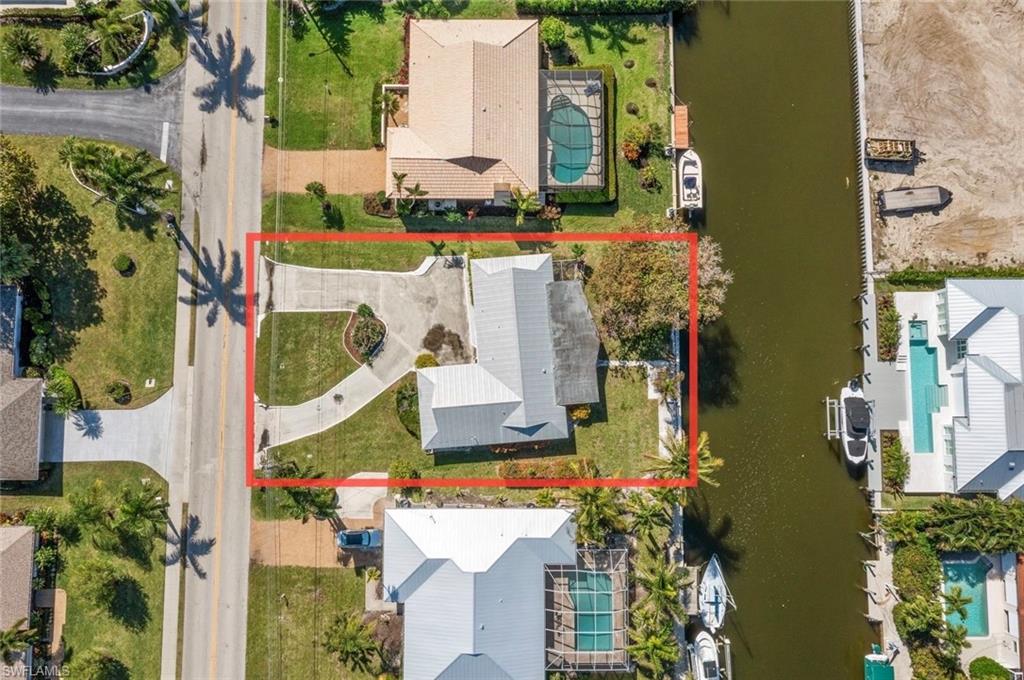 1696 Sandpiper Street Naples, FL 34102 - Photo 4 of 5 aerial view of a house with a yard and large trees