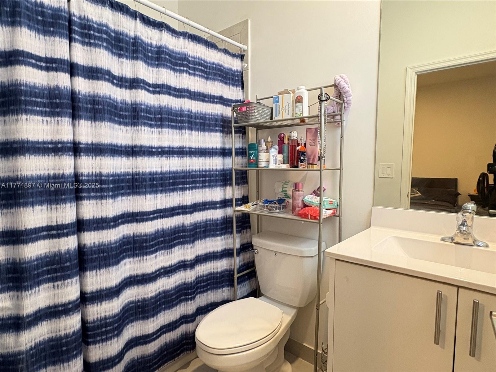 11772 Southwest 247th Terrace, Unit 11772 Homestead, FL 33032 - Photo 15 of 27 a bathroom with a sink toilet vanity and shower