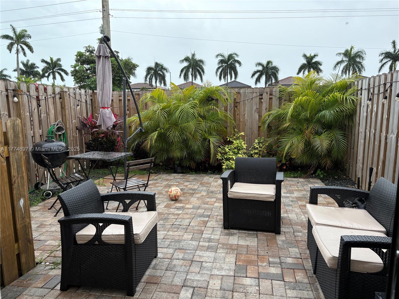 11772 Southwest 247th Terrace, Unit 11772 Homestead, FL 33032 - Photo 18 of 27 a view of a patio with couches and potted plants