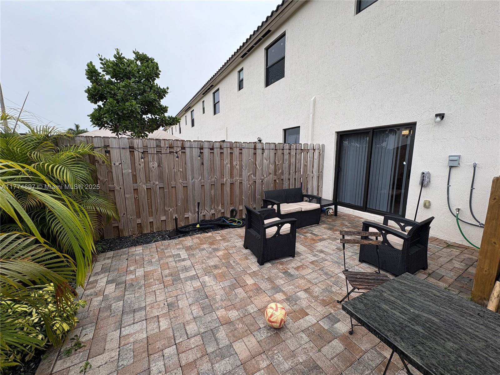 11772 Southwest 247th Terrace, Unit 11772 Homestead, FL 33032 - Photo 20 of 27 a view of a backyard with furniture