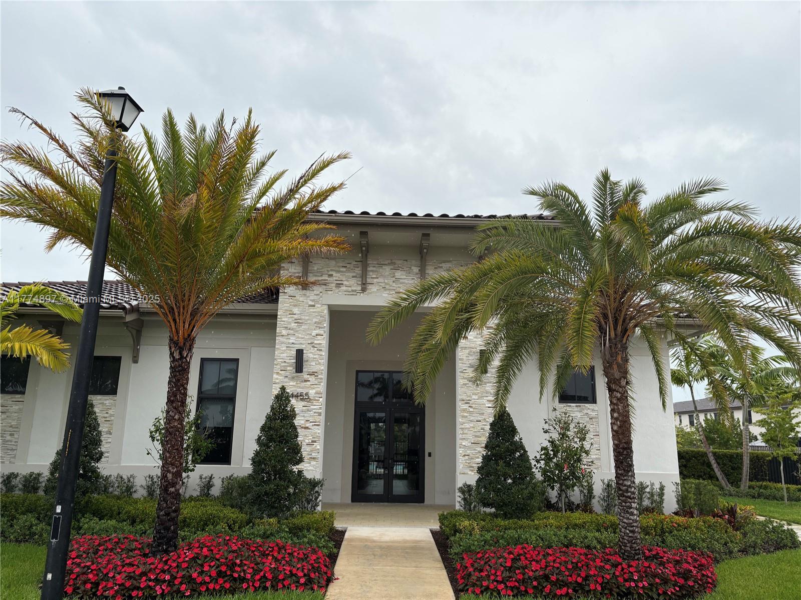 11772 Southwest 247th Terrace, Unit 11772 Homestead, FL 33032 - Photo 21 of 27 front view of a house with a flower garden