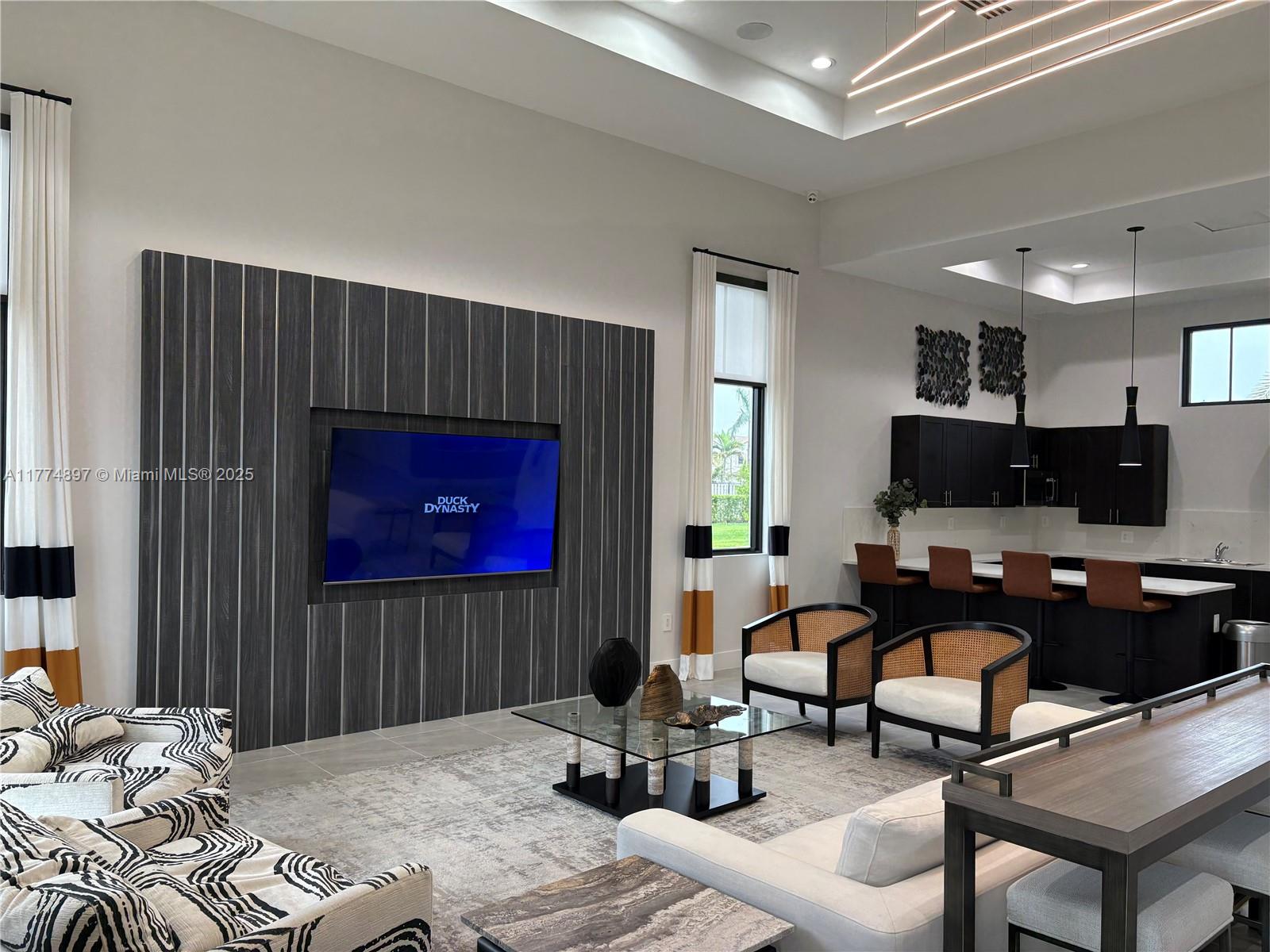 11772 Southwest 247th Terrace, Unit 11772 Homestead, FL 33032 - Photo 22 of 27 a bedroom with a bed a couch and a flat screen tv
