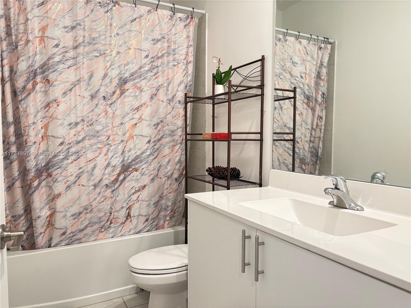 11772 Southwest 247th Terrace, Unit 11772 Homestead, FL 33032 - Photo 7 of 27 a bathroom with a sink and a toilet