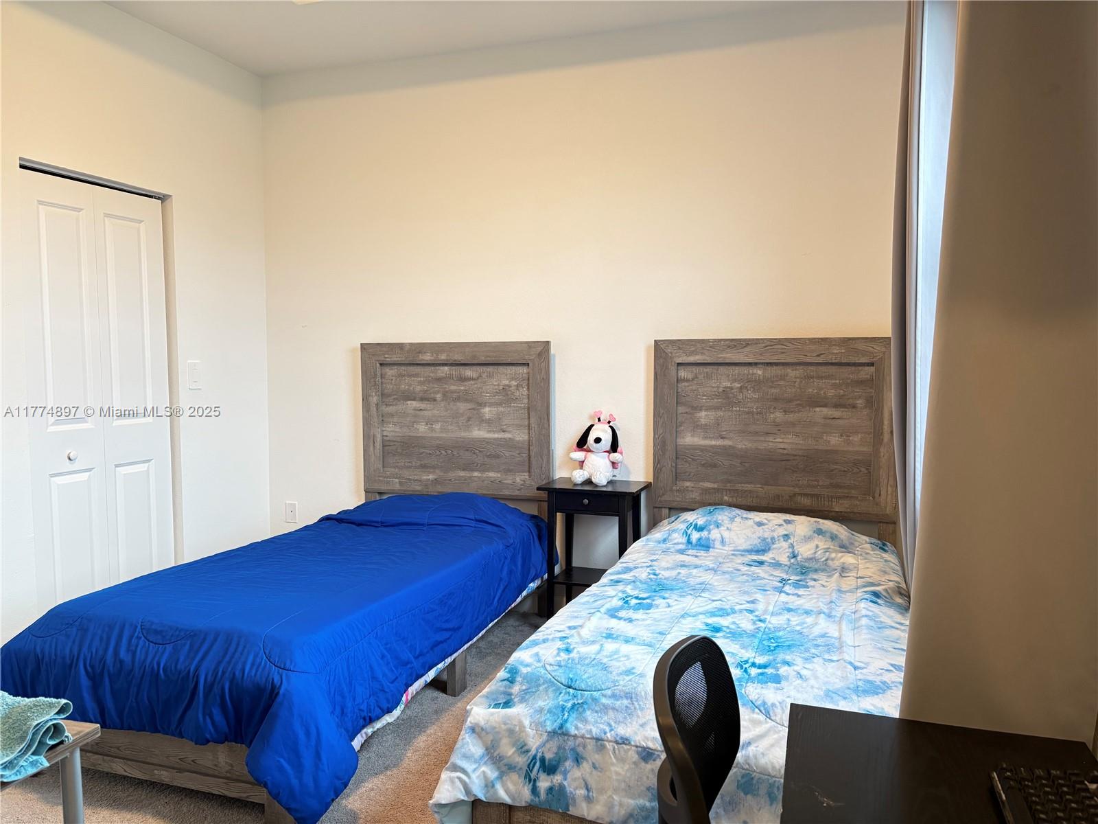 11772 Southwest 247th Terrace, Unit 11772 Homestead, FL 33032 - Photo 9 of 27 a bedroom with a bed and dresser