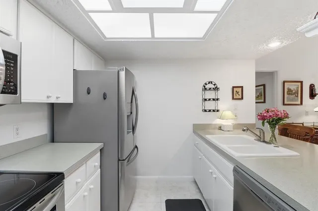 a kitchen with a sink stove and refrigerator