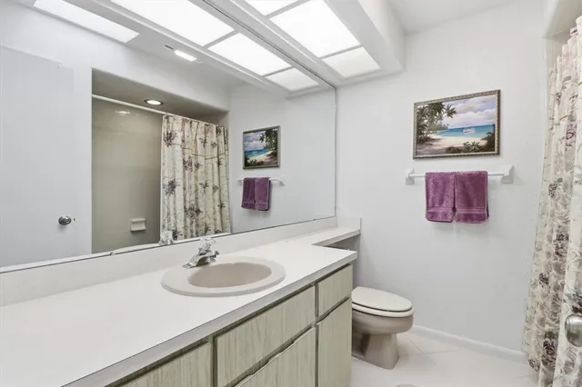 a bathroom with a sink toilet and a mirror