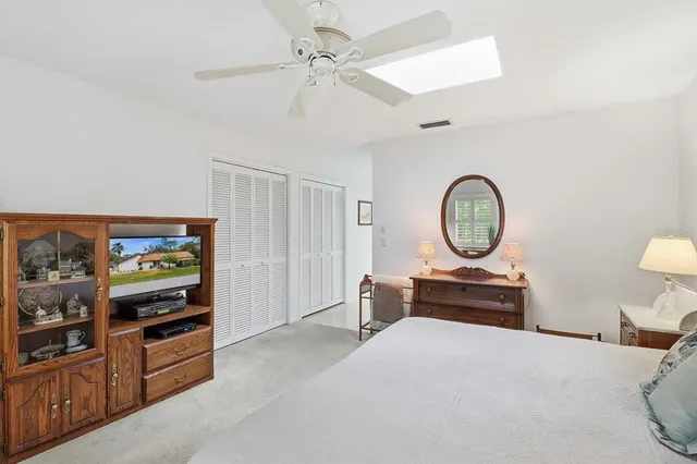 a bedroom with bed and a chandelier