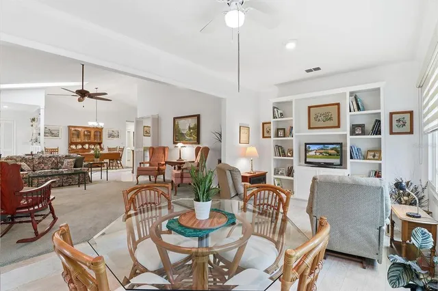 a dining room with furniture a rug and wooden floor