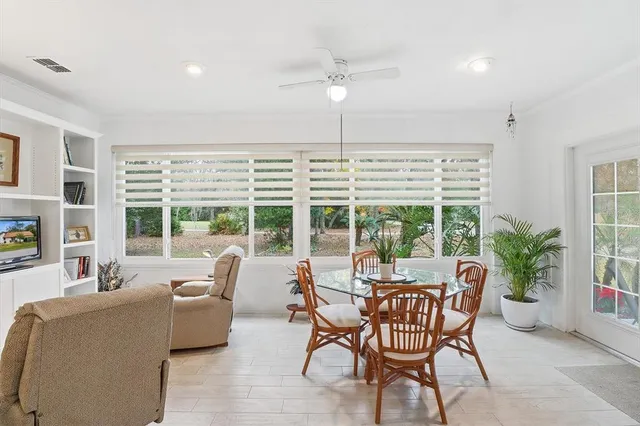 a living room with furniture and large windows