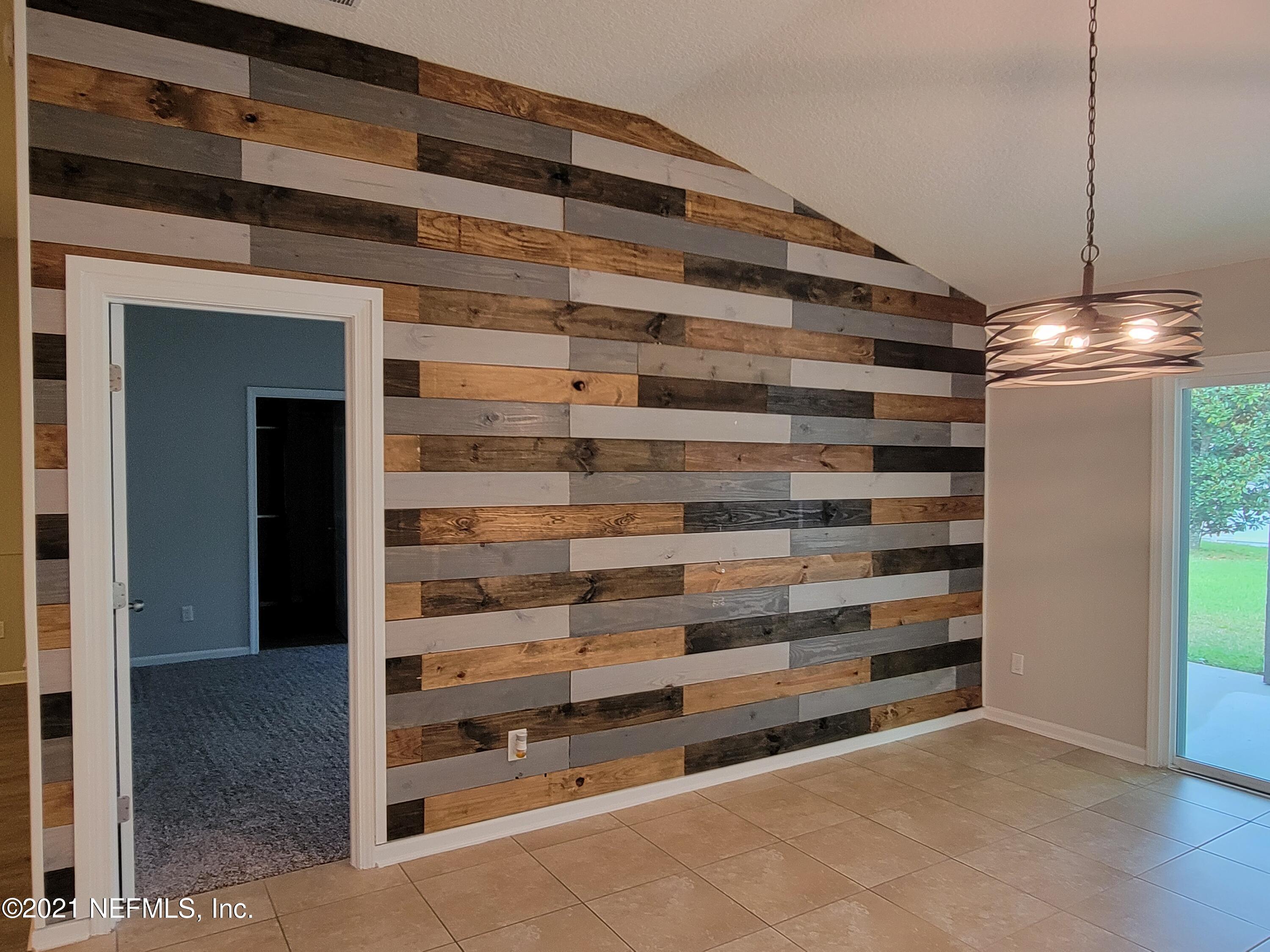 13471 Devan Lee Drive East Jacksonville, FL 32226 - Photo 5 of 10 a view of room with shelves and a ceiling fan