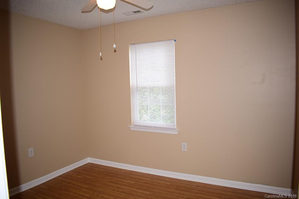 138 Bluffton Road Mooresville, NC 28115 - Photo 11 of 19 an empty room with wooden floor and a window