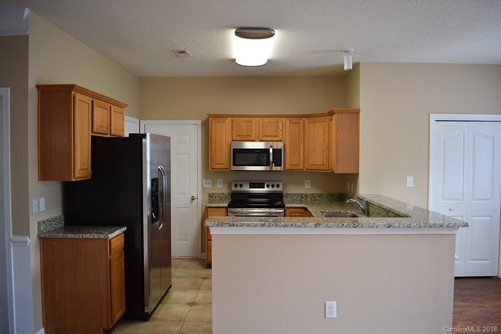 138 Bluffton Road Mooresville, NC 28115 - Photo 5 of 19 a kitchen with stainless steel appliances granite countertop a refrigerator stove top oven a sink and dishwasher