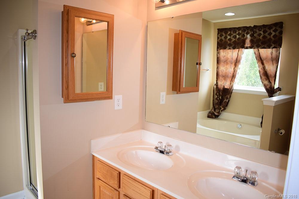 138 Bluffton Road Mooresville, NC 28115 - Photo 8 of 19 a bathroom with a sink a mirror and shower