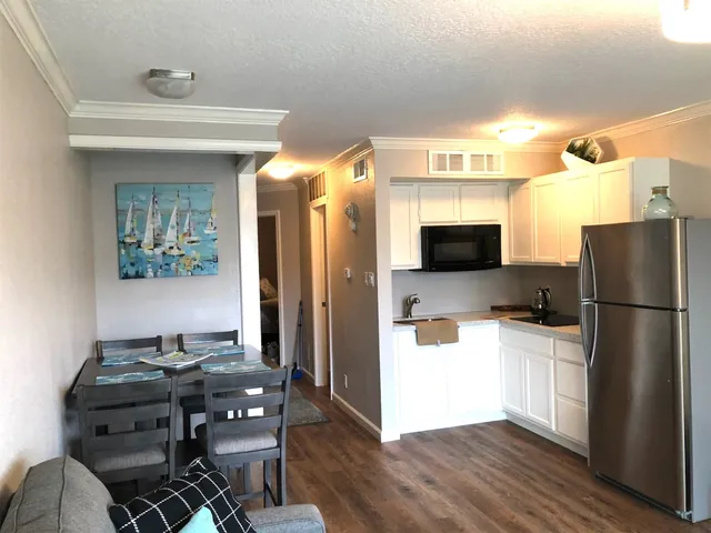 a kitchen with stainless steel appliances a stove a refrigerator and a sink