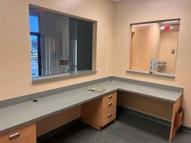a kitchen with granite countertop a sink and a stove