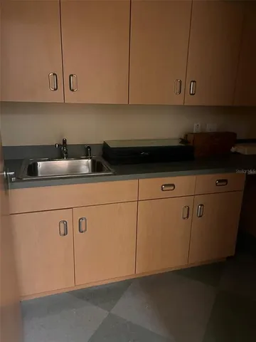 a kitchen with a sink and cabinets