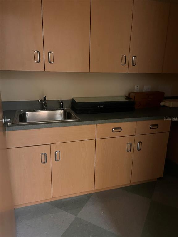 5999 Dundee Road, Unit 800 Winter Haven, FL 33881 - Photo 16 of 20 a kitchen with granite countertop cabinets and white appliances
