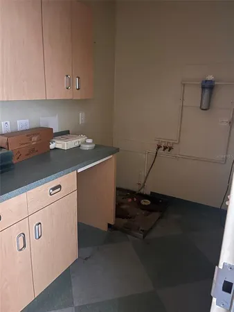 a kitchen with cabinets and a refrigerator