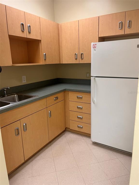 5999 Dundee Road, Unit 800 Winter Haven, FL 33881 - Photo 20 of 20 a kitchen with cabinets and a refrigerator