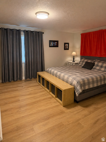 287 100 North Orem, UT 84057 - Photo 6 of 18 Bedroom with light wood-style flooring and a textured ceiling