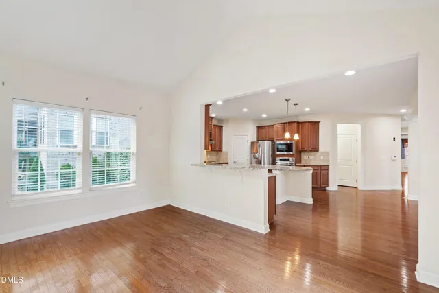 a view of a kitchen with furniture and wooden floor