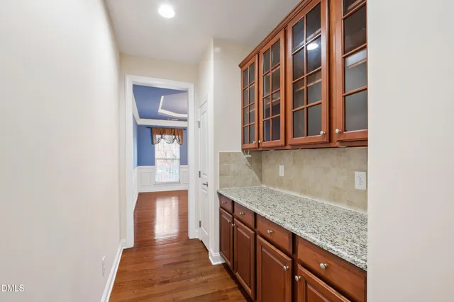 a kitchen with stainless steel appliances granite countertop lots of counter top space and wooden floor