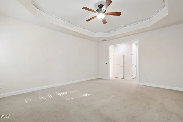 an empty room with a empty space and a ceiling fan
