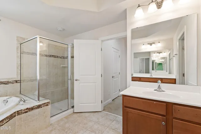 a bathroom with a tub sink and mirror
