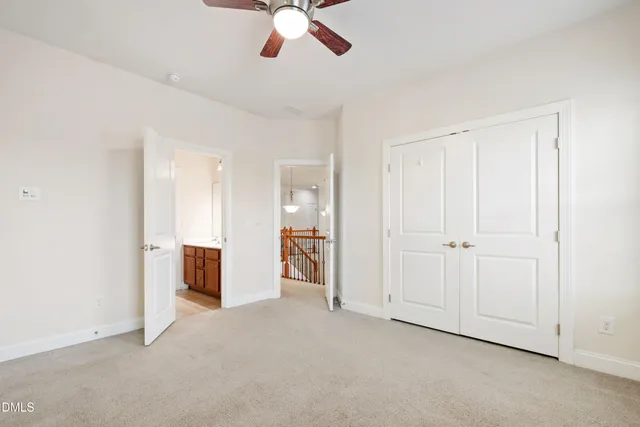 an empty room with chandelier fan
