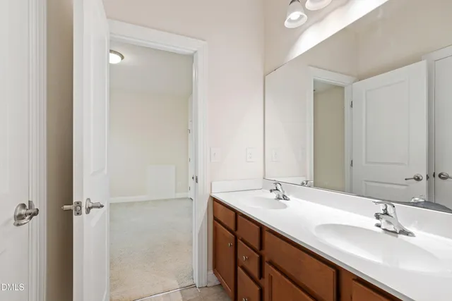a bathroom with 2 sink and a mirror