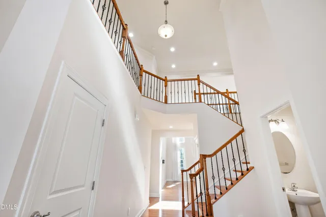 a view of staircase with railing and white walls