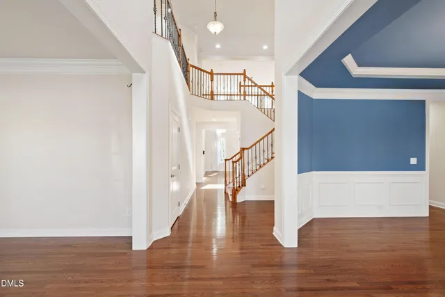 a view of entryway and hall with wooden floor