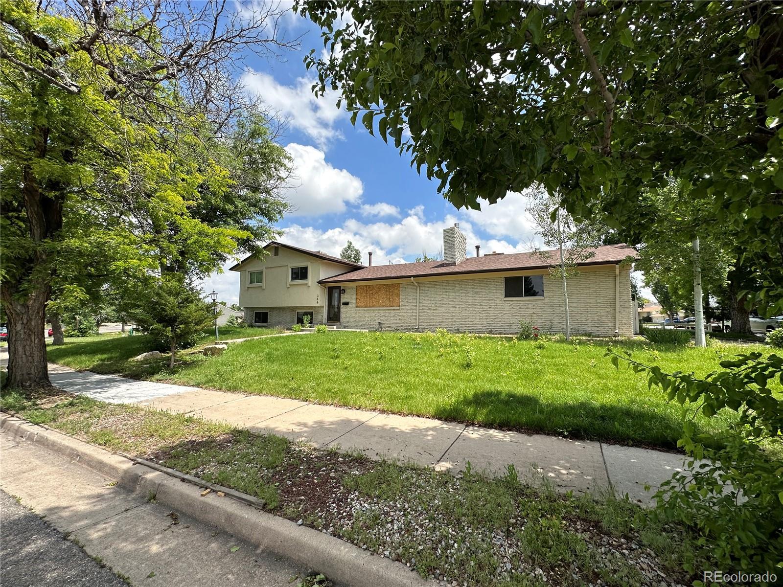 a view of backyard of house with green space