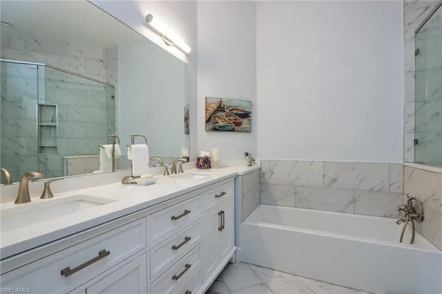 a bathroom with a tub sink and mirror