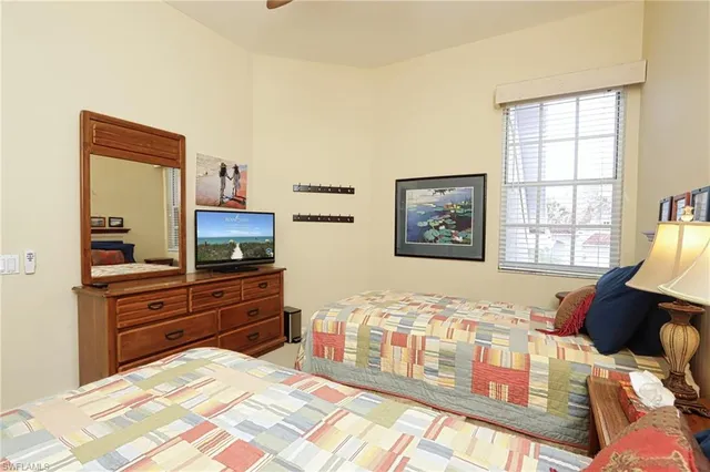 a bedroom with a bed and a television