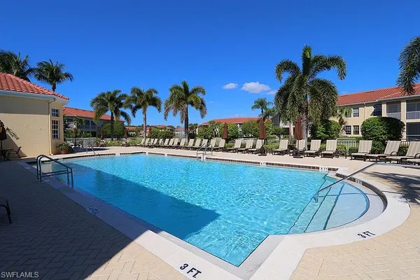 a view of a swimming pool with outdoor seating