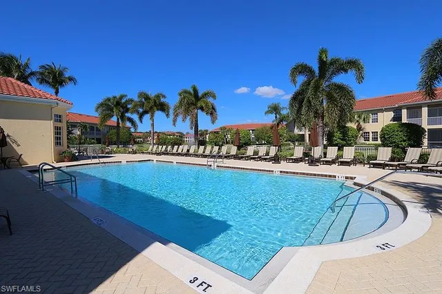 a view of a swimming pool with outdoor seating