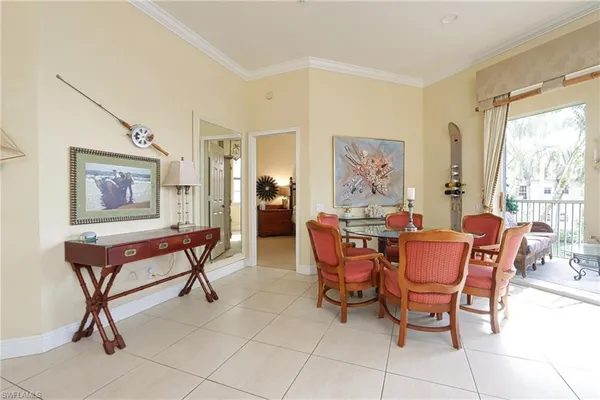 a dining room with furniture and window