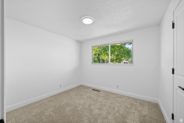 2267 West 4350th Street South Roy, UT 84067 - Photo 16 of 32 Unfurnished room featuring carpet flooring and a textured ceiling