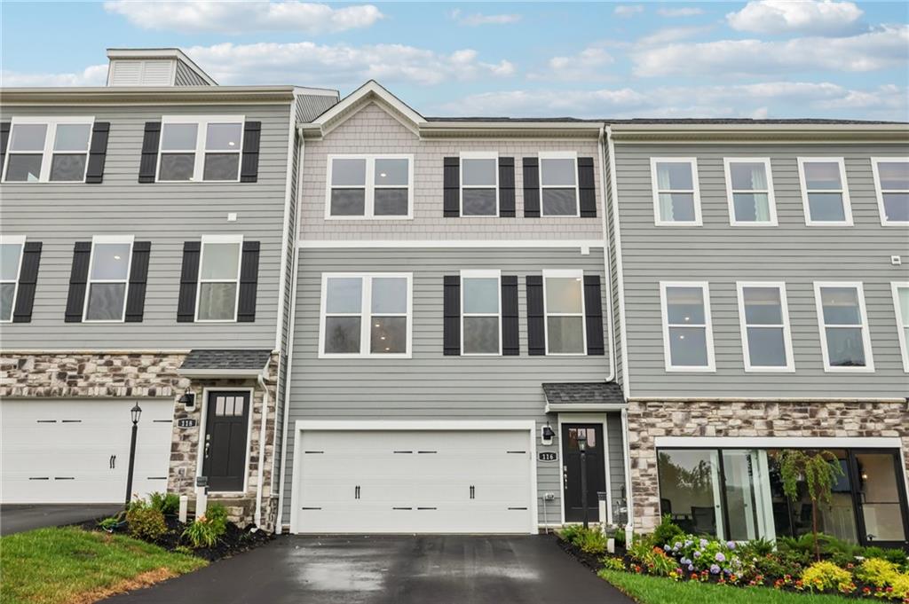 116 River Ridge Drive Coraopolis, PA 15108 - Photo 2 of 27 a front view of a building with a garden