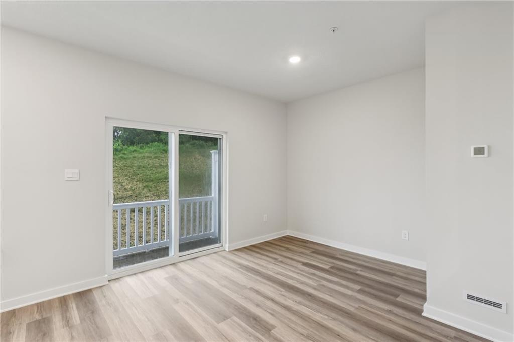 116 River Ridge Drive Coraopolis, PA 15108 - Photo 8 of 27 a view of an empty room with wooden floor and a window